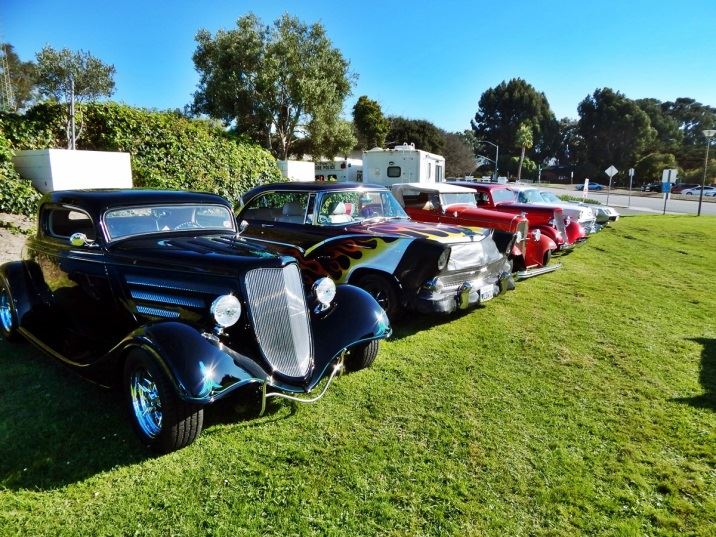 Row of classic cars parked on City Hall lawn